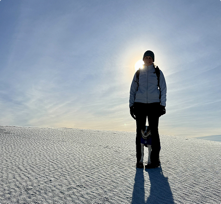 heidi-stands-with-cheza-dog-desert-IAT Heidi stands with her dog in a sunny desert.